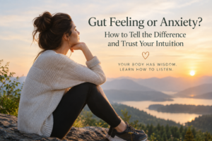 Woman sitting quietly in nature reflecting on the difference between gut feelings, intuition, anxiety, and body signals.